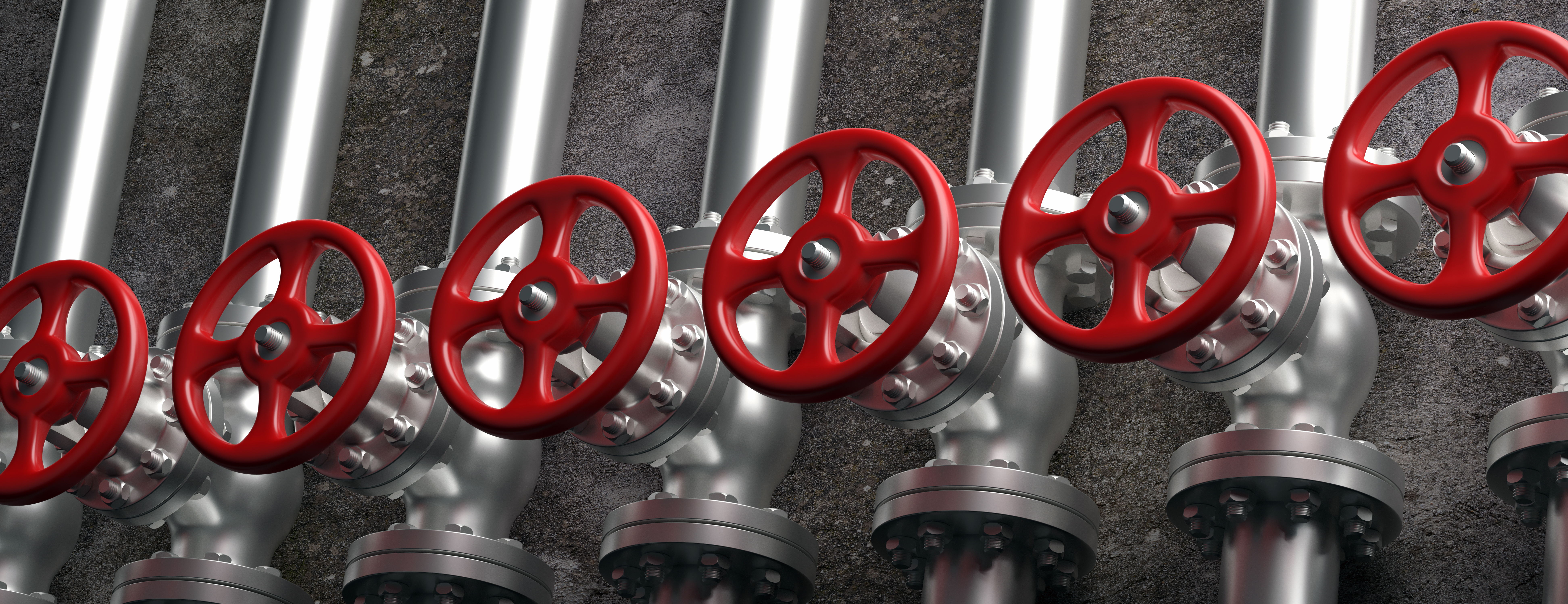 Red industrial valves on silver process piping
